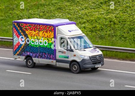 Ocado new Fruit Van livery & Morrisons supermarket grocery delivery service food store vehicles; online delivery fleet delivering, deliveries, groceries & household essentials; travelling on the M6 motorway, UK Stock Photo