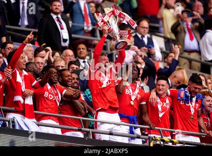 Nottingham Forest's Joe Worrall (centre) lifts the trophy in the stands ...