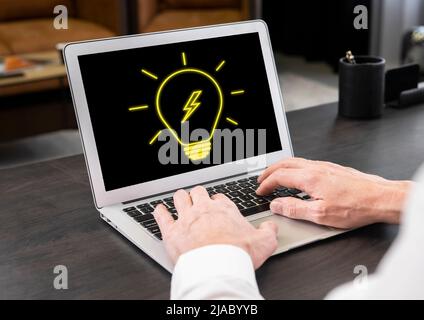 Man working on laptop with bulb at screen. Innovation, bright new idea in business, breakthrough, finding solution from difficult situation concept. Hands at keyboard closeup. High quality photo Stock Photo