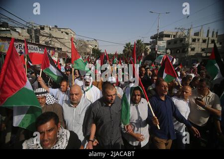 Gaza. 29th May, 2022. Palestinian people protest against the flag march in East Jerusalem, in the southern Gaza Strip city of Rafah, on May 29, 2022. The controversial flag march organized by Israeli far-right groups is due to take place on Sunday to mark Jerusalem Day, which commemorates the unification of the city after Israel annexed East Jerusalem in 1967. Its route is scheduled to pass by the Damascus Gate and the Islamic quarter in the old city. Credit: Khaled Omar/Xinhua/Alamy Live News Stock Photo