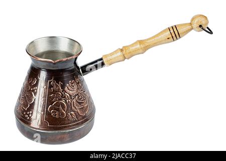 Turkish coffee pot. Ibrik - small copper coffee pot isolated on white background. File contains clipping path. Stock Photo