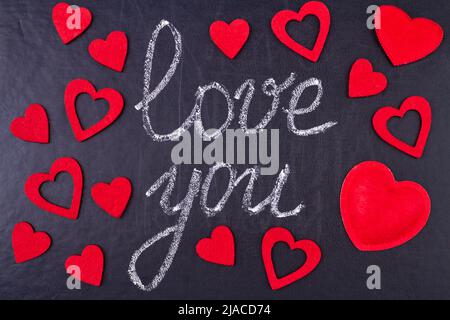 Handwritten chalk inscription I love you on black chalkboard. Happy Valentines Day. Stock Photo