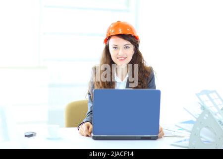 Beautiful businesswoman engineer, working on a laptop in the office. Stock Photo