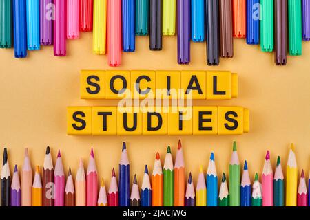The inscription social studies written on yellow cubes. Flat lay composition. Education and knowledge concept. Stock Photo