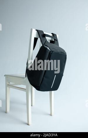 modern stylish backpack on chair studio shot Stock Photo