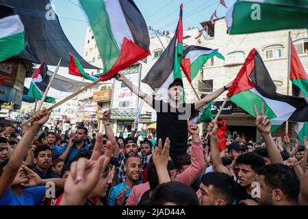 Gaza. 29th May, 2022. Palestinian people protest against the flag march in Jabalia, northern Gaza Strip, on May 29, 2022. Tens of thousands of Palestinians have joined public protests organized in the West Bank and the Gaza Strip against the flag march on Sunday. The controversial flag march through Jerusalem's Old City took place on Sunday to mark Jerusalem Day, which commemorates the unification of the city after Israel annexed East Jerusalem in 1967. Credit: Rizek Abdeljawad/Xinhua/Alamy Live News Stock Photo