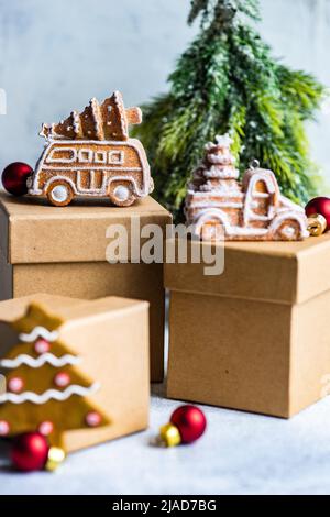 Christmas gingerbread cookies on gift boxes next to a Christmas tree ornament Stock Photo