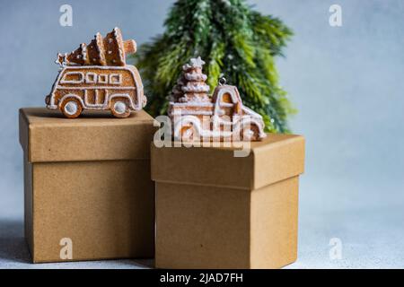 Christmas gingerbread cookies on gift boxes next to a Christmas tree ornament Stock Photo