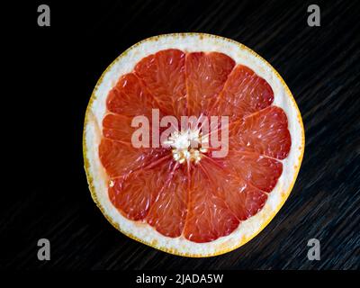Sliced grapefruit on the dark background, cut grapefruit Stock Photo