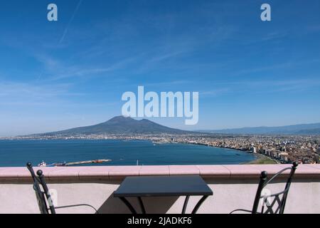 View of Mt Vesuvius from balcony with tables and chairs, Pompeii Stock Photo