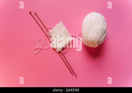 knitting needles on pink background Stock Photo