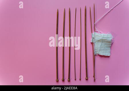knitting needles on pink background Stock Photo