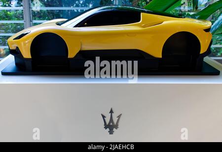 Yellow model of a Maserati sport car with logo on display. Maserati Headquarters. Modena, Italy. Stock Photo