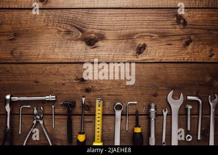Flat lay with various work tools on wooden background working table. Top view on new hand tool set for repair, construction kit, overhead. Must-have for men. Equipment for building. Industry concept Stock Photo