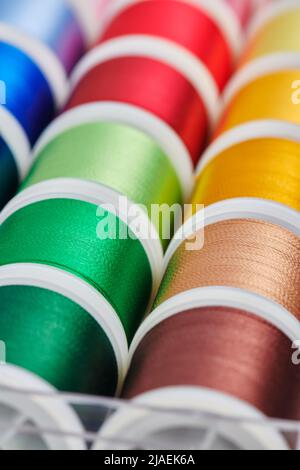 Background of spools with multicolored sewing threads Stock Photo
