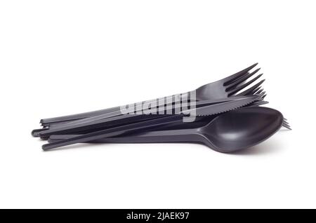 a bunch of black plastic spoons, forks and knives isplated on white background Stock Photo