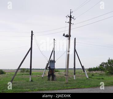 Electricity transformer substation against sky Stock Photo