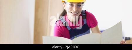 Cute woman architect working with drawings Stock Photo