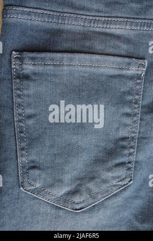 Close up detail of back pocket of light blue jeans denim Stock Photo