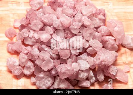 pile of rose quartz stones on orange background Stock Photo
