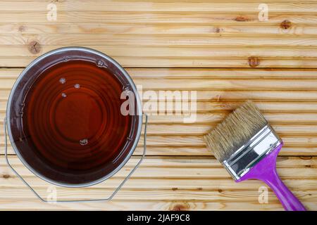 Painting new wooden boards larch floors for patio by special waterproof protective oil. View from above. Stock Photo
