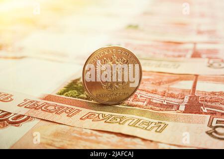 Russian banknotes and coins rubles. Banknote with inscription five thousand rubles and coins of 5 and 10 rubles. Background made of money. Stock Photo