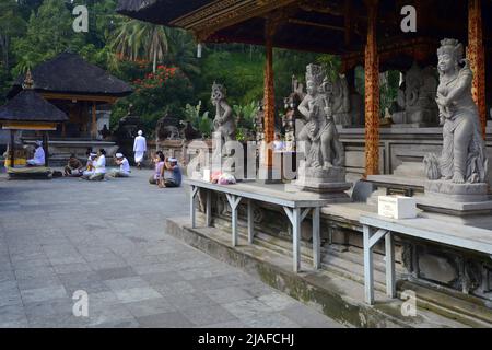 believers praying in the water temple of Tirta Empul, Indonesia, Bali Stock Photo