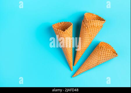Waffle ice cream cups on a blue background. Stock Photo