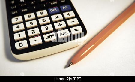 Engineering calculator keyboard and yellow ballpoint pen Stock Photo