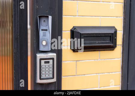 intercom panel with a video camera on the brick fence of private house Stock Photo