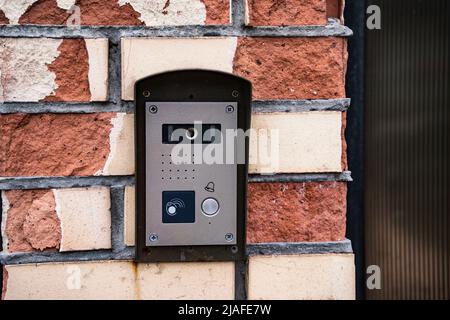 intercom panel with a video camera on the brick fence of private house Stock Photo