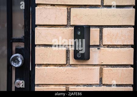 intercom panel with a video camera on the brick fence of private house Stock Photo