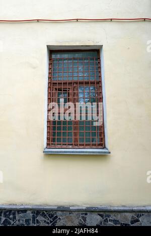 Old wooden window with metal bars Stock Photo