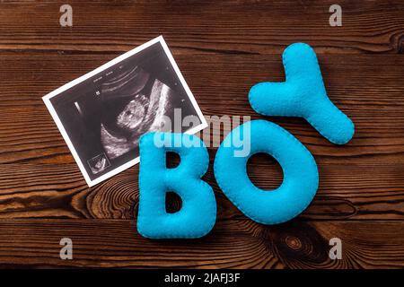 Ultrasound scan of unborn baby with letters boy Stock Photo