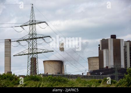 RWE Weisweiler Lignite-fired Power Plant In NRW. Steaming Cooling Tower With A High Voltage Pylon Next To It