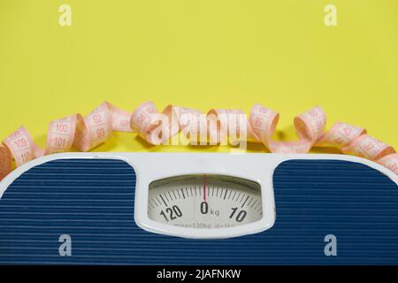 https://l450v.alamy.com/450v/2jafnkw/floor-blue-scales-and-centimeter-measuring-tape-on-a-yellow-background-top-view-the-concept-of-weight-loss-and-weight-control-2jafnkw.jpg