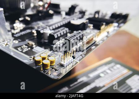 Gold-plated capacitors and connectors on the motherboard of a modern personal computer Stock Photo