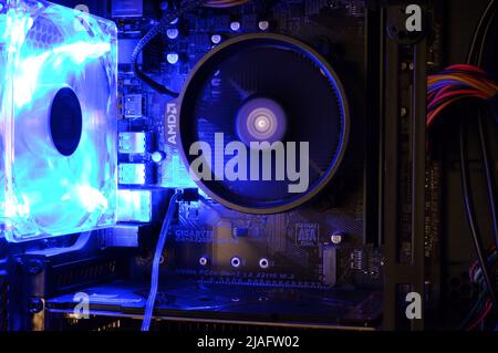 Ryazan, Russia - April 4, 2021: Motherboard with AMD cooler and luminous rotating fan Stock Photo