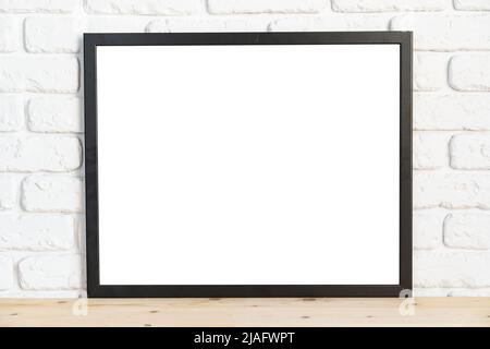 Photo frames on floor over white brick wall Stock Photo