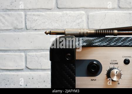 Black guitar amplifier with jack cable Stock Photo