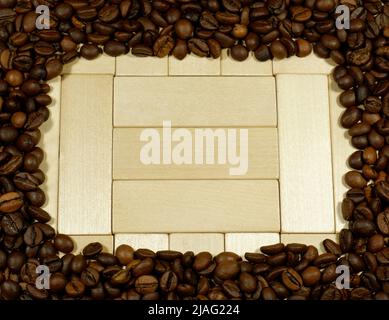 Frame of coffee beans on wooden background Stock Photo