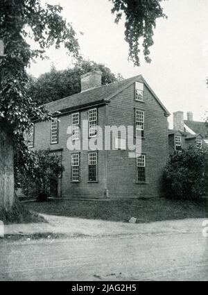 The 1920 caption reads: “Lexington, Massachusetts—the house in which Samuel Adams and John Hancock were asleep when roused by Paul Revere.” The Hancock-Clark House in Lexington, Massachusetts, is where John Hancock and Samuel Adams were awakened by Paul Revere on April 18, 1775. The men were asleep in “the parlor” of the house built in 1737 by Thomas Hancock for his father Rev. John Hancock. Stock Photo