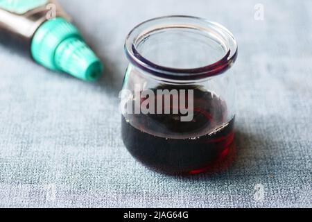 maple syrup in a small glass jar on table  Stock Photo