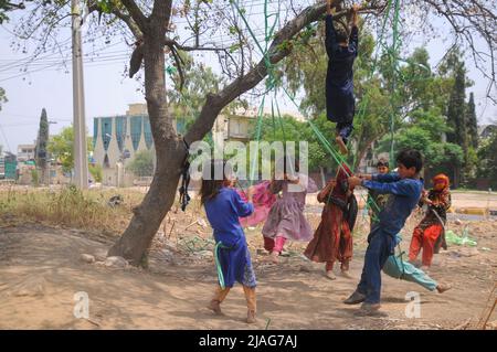 Islamabad, Pakistan. 29th May, 2022. Afghan refugee children play on a local swing in a suburb of Islamabad, Pakistan, on May 29, 2022. (Photo by Raja Imran/Pacific Press/Sipa USA) Credit: Sipa USA/Alamy Live News Stock Photo