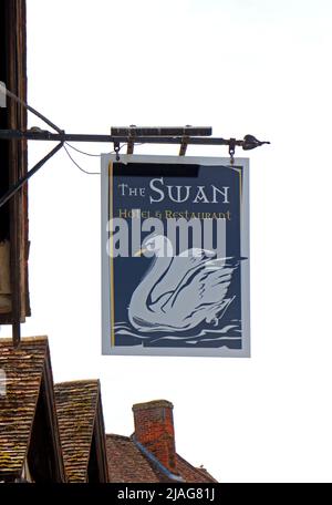 A view of the sign for the well preserved timber-framed Swan Hotel and former coaching inn in the High Street at Lavenham, Suffolk, England, UK. Stock Photo