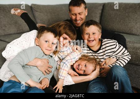 Portrait of happy children spending leisure time with parents at home Stock Photo