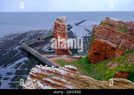 Red sandstone cliffs of German North Sea island of Helgoland with the Lange Anna sea stack Stock Photo