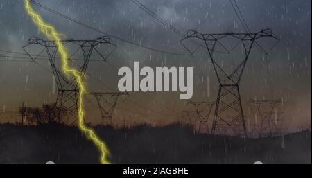 Image of heavy rain, storm with yellow lightning and grey clouds over electric pylons Stock Photo