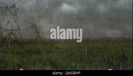 Image of heavy rain, storm with lightning and grey clouds over electric pylons Stock Photo