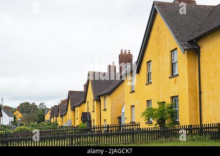 Row of distinctively painted cottages in an East Devon village, UK Stock Photo